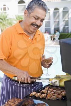 Royalty Free Photo of a Man Barbecuing