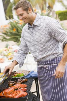 Royalty Free Photo of a Man Barbecuing