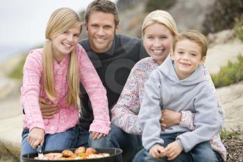 Royalty Free Photo of a Family Barbecuing at the Beach