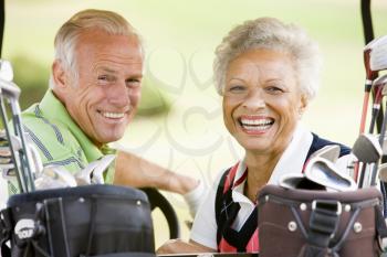 Royalty Free Photo of a Couple in a Golf Cart