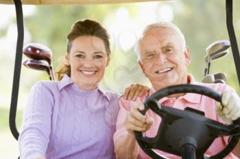 Royalty Free Photo of a Couple in a Golf Cart