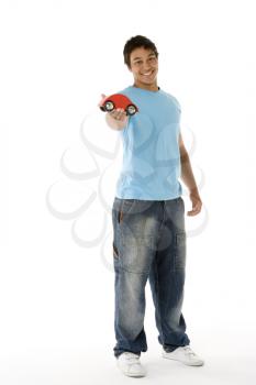 Royalty Free Photo of a Teenage Boy With a Toy Car