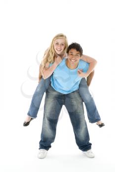 Royalty Free Photo of a Teenage Boy Giving a Girl a Piggyback Ride