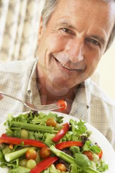 Royalty Free Photo of a Man Eating Salad