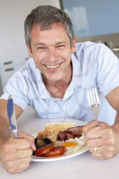 Royalty Free Photo of a Man Eating Bacon and Eggs