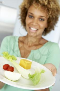 Royalty Free Photo of a Woman Holding a Plate of Healthy Food