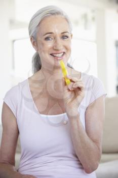 Royalty Free Photo of a Woman Eating a Pineapple