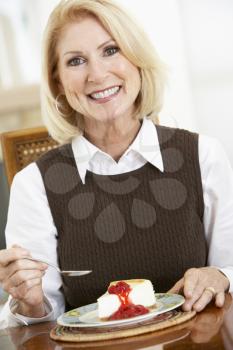 Royalty Free Photo of a Woman Eating Cheesecake