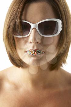 Royalty Free Photo of a Girl in Sunglasses With Sprinkles on Her Lips