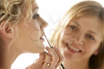 Royalty Free Photo of a Woman Applying Another Woman's Makeup