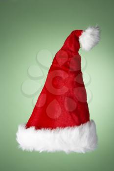 Royalty Free Photo of a Santa Hat on a Green Background