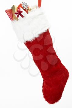 Christmas Stocking With Gifts Against White Background