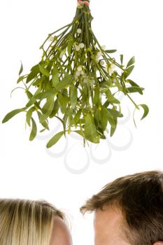 Royalty Free Photo of a Couple Under the Mistletoe