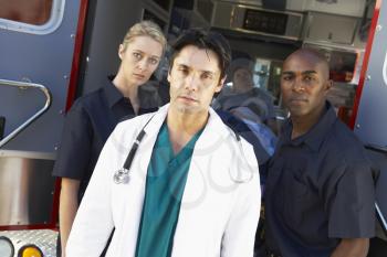 Royalty Free Photo of Paramedics and Doctors in Front of an Ambulance