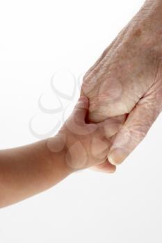 Royalty Free Photo of a Grandfather Holding a Baby's Hand