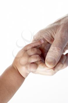 Royalty Free Photo of a Grandfather Holding a Baby's Hand