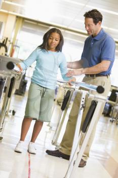 Royalty Free Photo of a Physiotherapist Working With a Little Girl