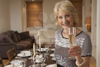 Royalty Free Photo of a Woman Throwing a Dinner Party