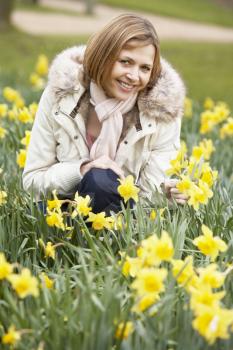 Royalty Free Photo of a Woman Kneeling in Daffodils