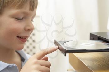 Royalty Free Photo of a Child Loading a CD