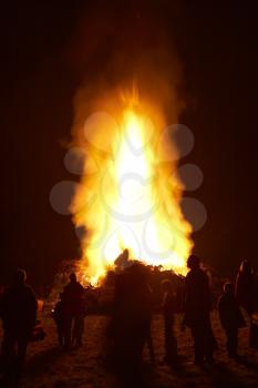 Royalty Free Photo of People Standing Around a Bonfire at Night