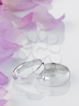 Royalty Free Photo of Wedding Rings and Rose Petals