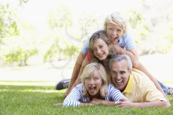 Royalty Free Photo of a Family Lying Down on the Grass