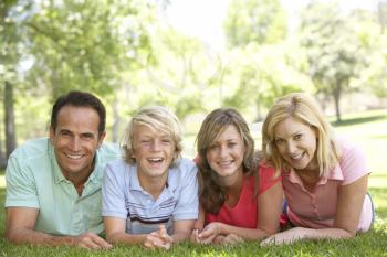 Royalty Free Photo of a Couple and Their Kids Lying on the Grass
