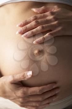 Royalty Free Photo of a Pregnant Woman Holding Her Stomach