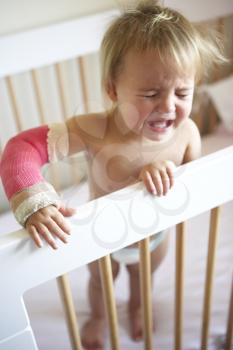 Royalty Free Photo of a Crying Child With Her Arm in a Cast