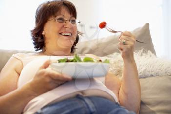 Royalty Free Photo of a Woman Eating a Salad