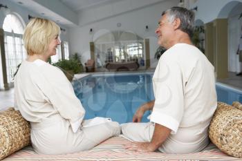 Royalty Free Photo of a Couple By a Swimming Pool