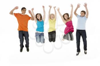 Group Of Five Young Children Jumping In Studio