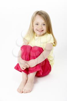 Royalty Free Photo of a Little Girl Sitting on the Floor