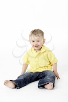 Royalty Free Photo of a Boy Sitting on the Floor