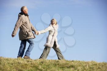 Royalty Free Photo of a Senior Man and Woman Walking in a Park