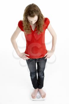 Royalty Free Photo of a Girl on Scales
