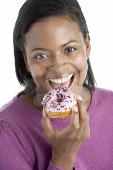 Royalty Free Photo of a Woman Eating a Doughnut