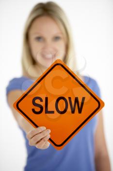Royalty Free Photo of a Woman Holding a Sign That Says Slow