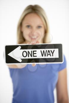 Royalty Free Photo of a Woman Holding a One-Way Sign