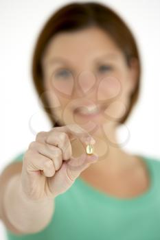 Royalty Free Photo of a Woman Holding a Capsule