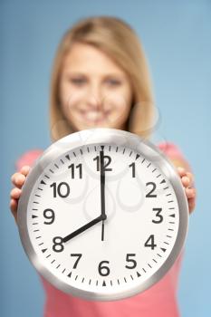 Royalty Free Photo of a Girl With a Clock