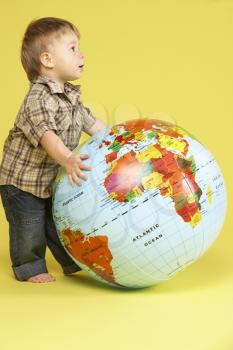 Royalty Free Photo of a Toddler With a Globe