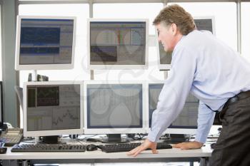 Royalty Free Photo of a Stock Trader Looking at Computer Monitors