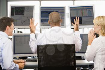 Royalty Free Photo of Stock Traders Viewing Monitors