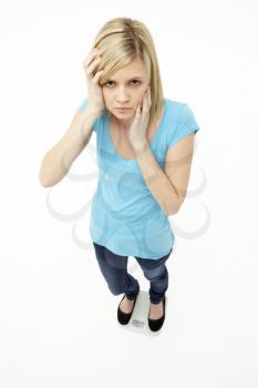 Worried Teenage Girl Standing In Studio