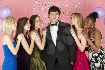 Royalty Free Photo of Teenage Girls Looking at a Boy in Formal Attire