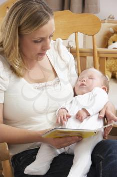 Royalty Free Photo of a Mother Reading to Her Sleeping Baby