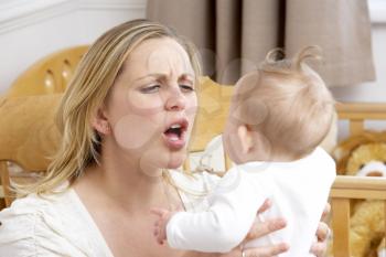 Royalty Free Photo of a Stressed Mother With a Baby