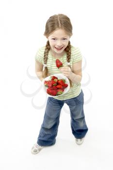Studio Portrait of Smiling Girl Holding Bowl of Strawberries